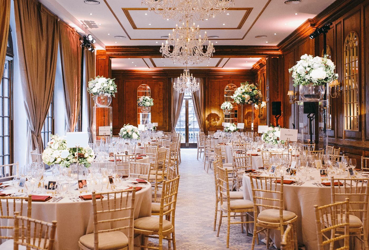 White wedding dinner set up with wood panelled walls