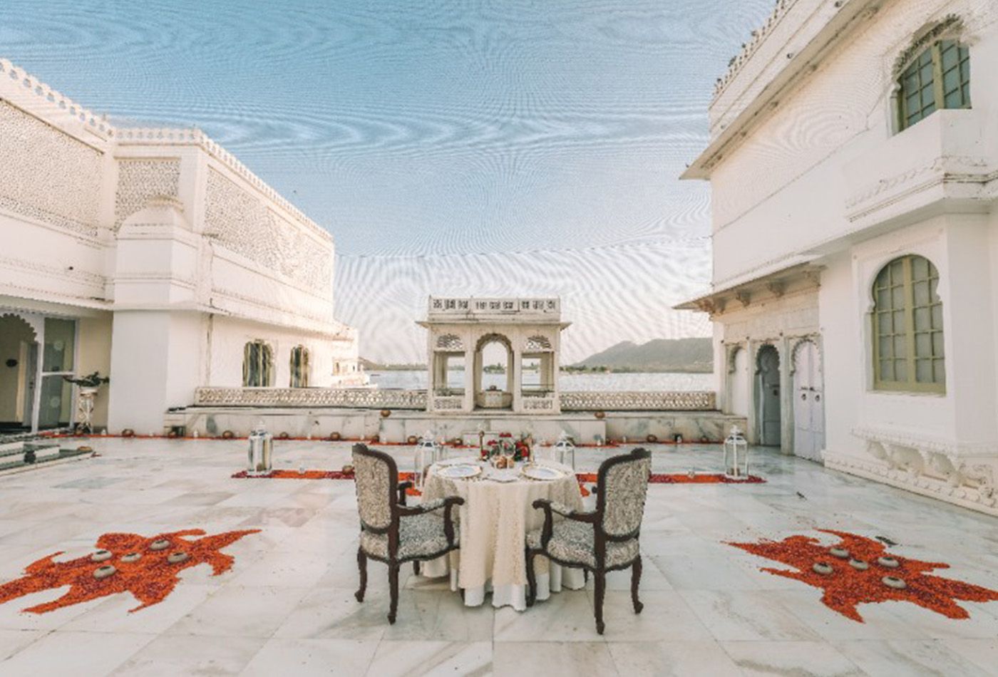 White balcony with dining table at the centre of it