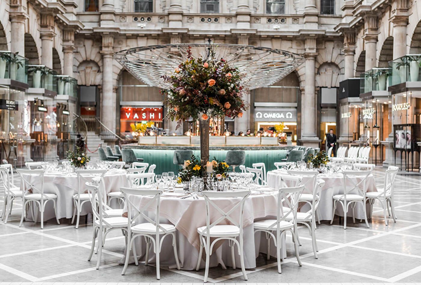 Courtyard wedding dining set up with orange tree centre pieces