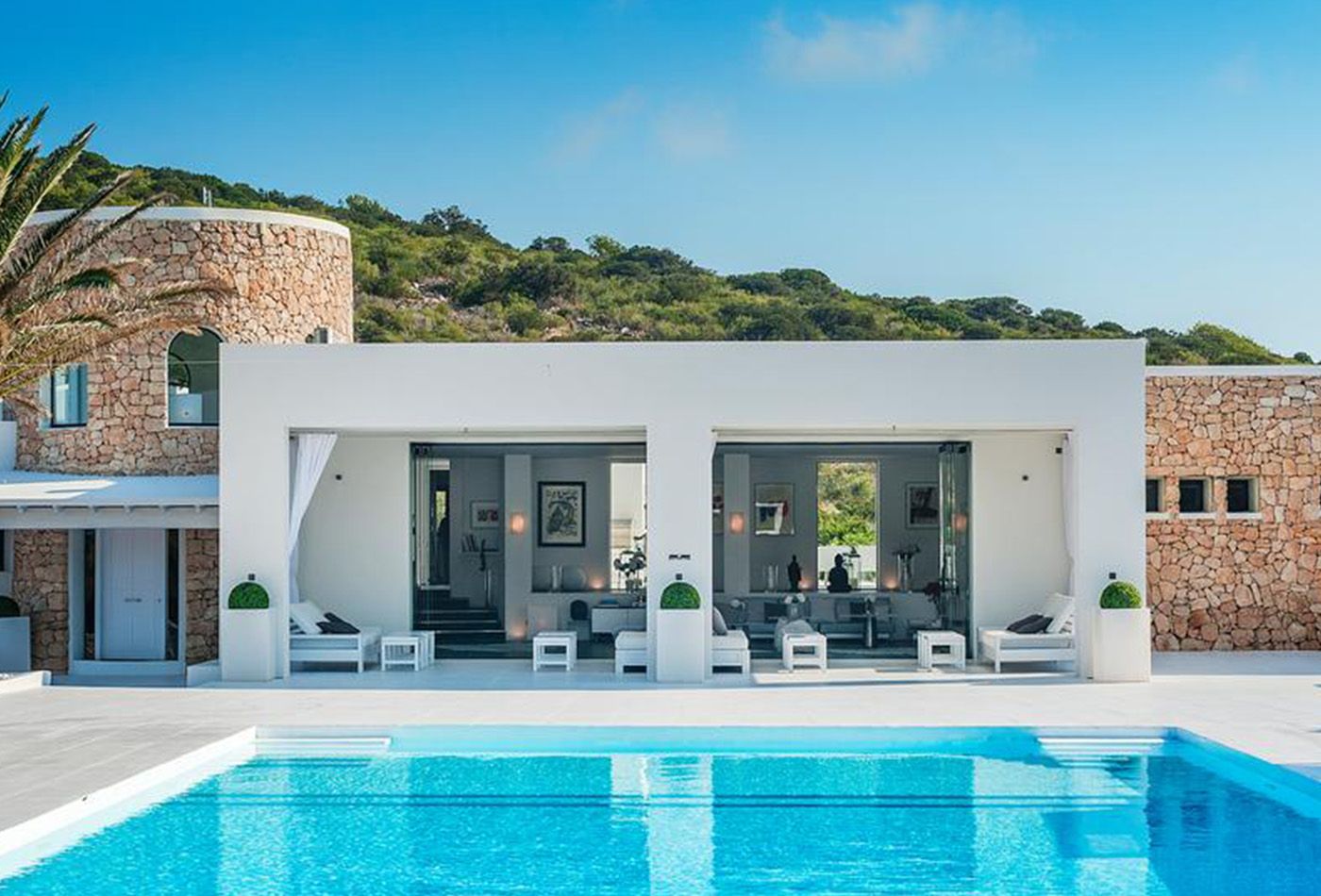 White modern building with bright blue pool