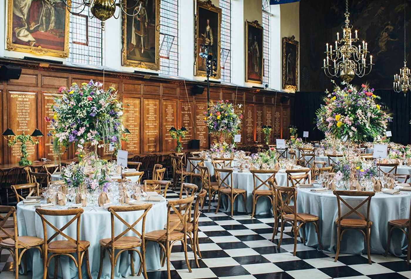 Wedding dining room with round tables and large floral centre pieces