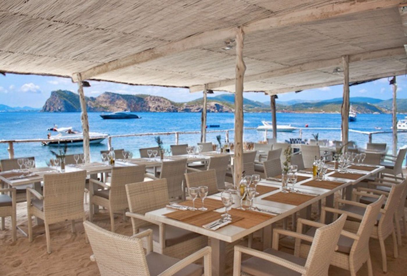 Informal restaurant looking out onto the sea, yachts in the distance