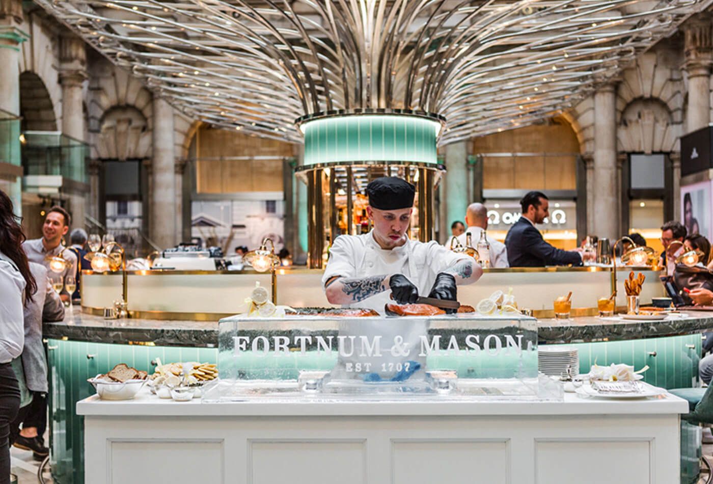 Chef preparing food on a neutral and turquoise food bar