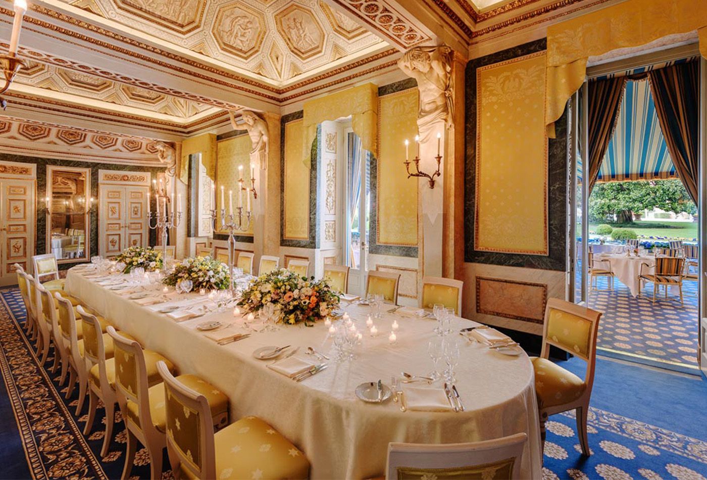 Grand dining hall with golden chairs, walls and ceiling art