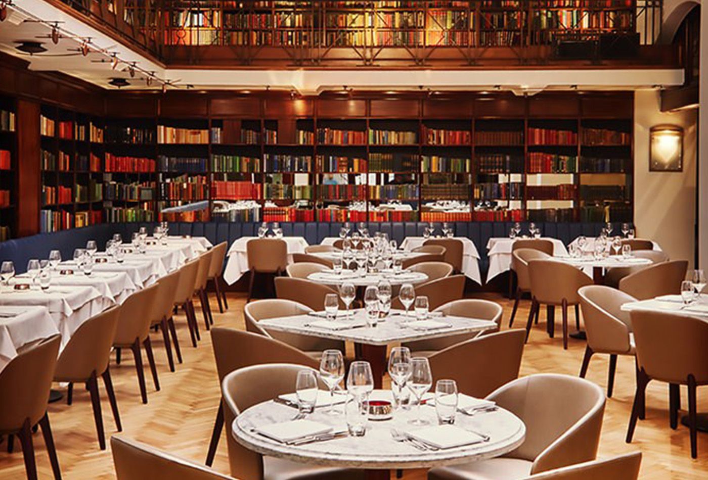 Restaurant set up in large library room surrounded by books