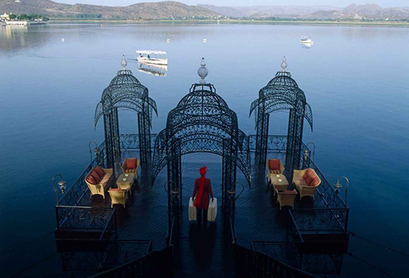 Floating trellis platform with seating and tables, overlooking beautiful lake