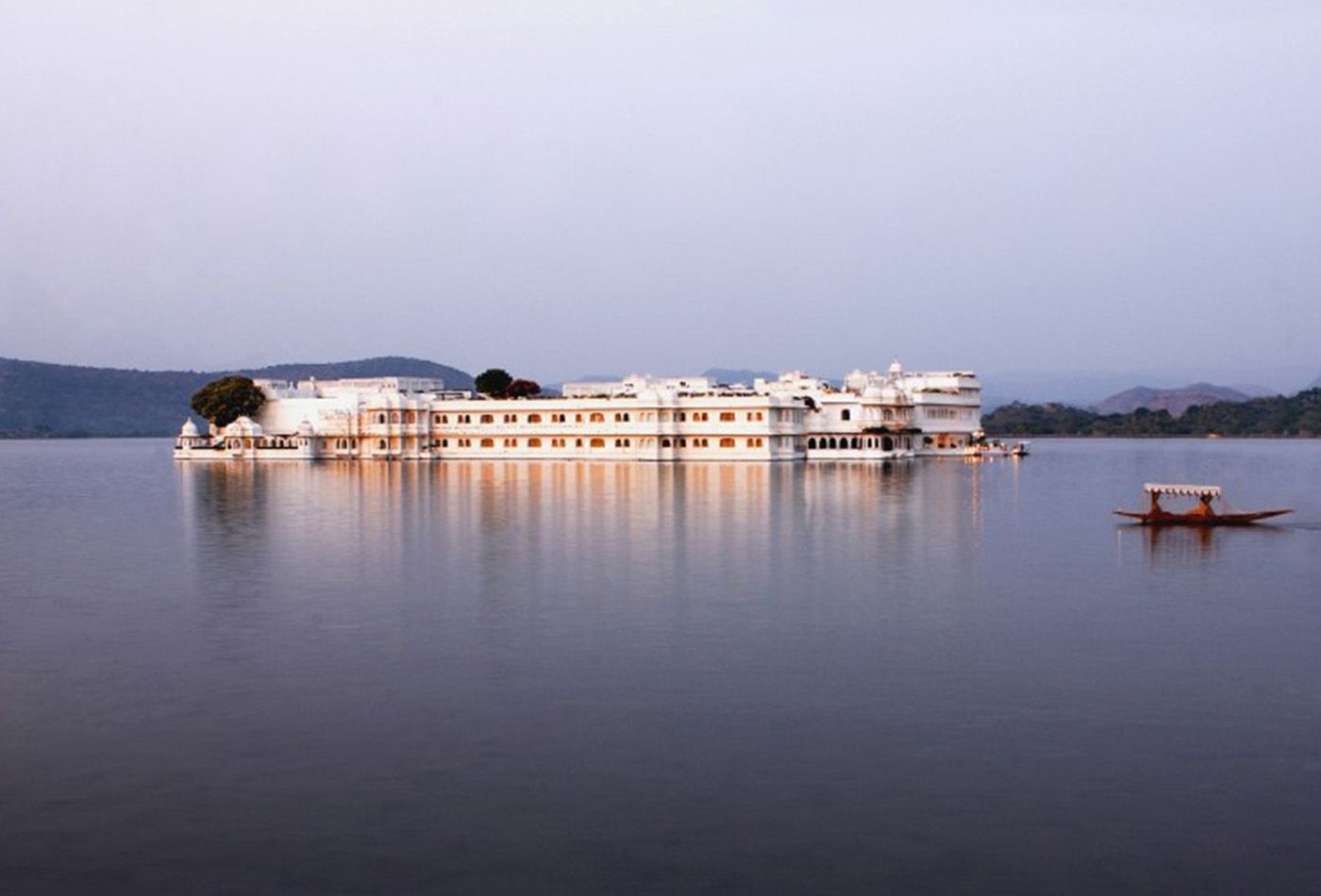 A marble building floating in the middle of Lake Pichola