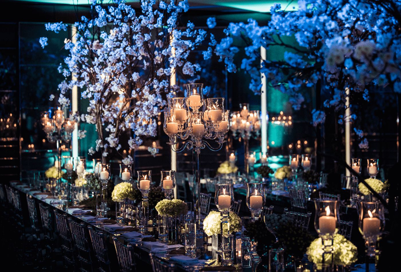 Dark dining set up with blossom trees .jpg