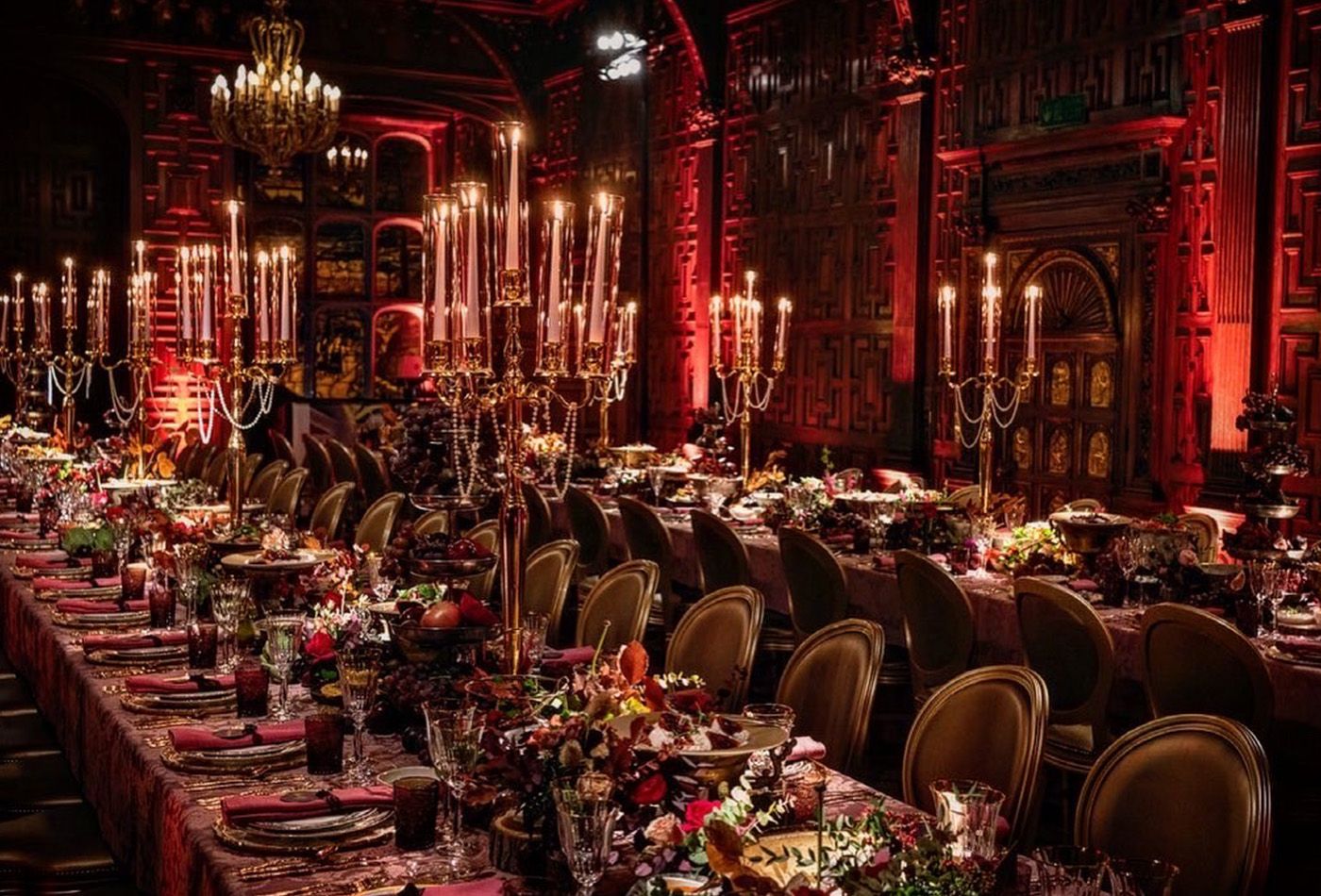 Majestic Great Hall overlooked by cheeky cherubs, beautiful stained glass windows and intricate wood carvings, lit entirely by hundreds of candles