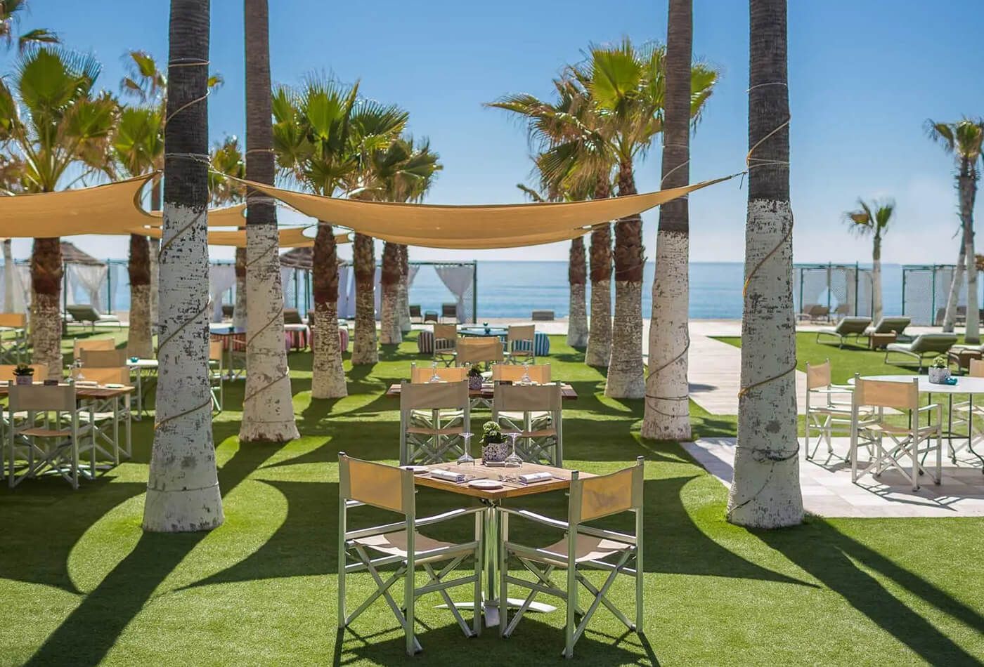 Outdoor shaded dining space overlooking the sea