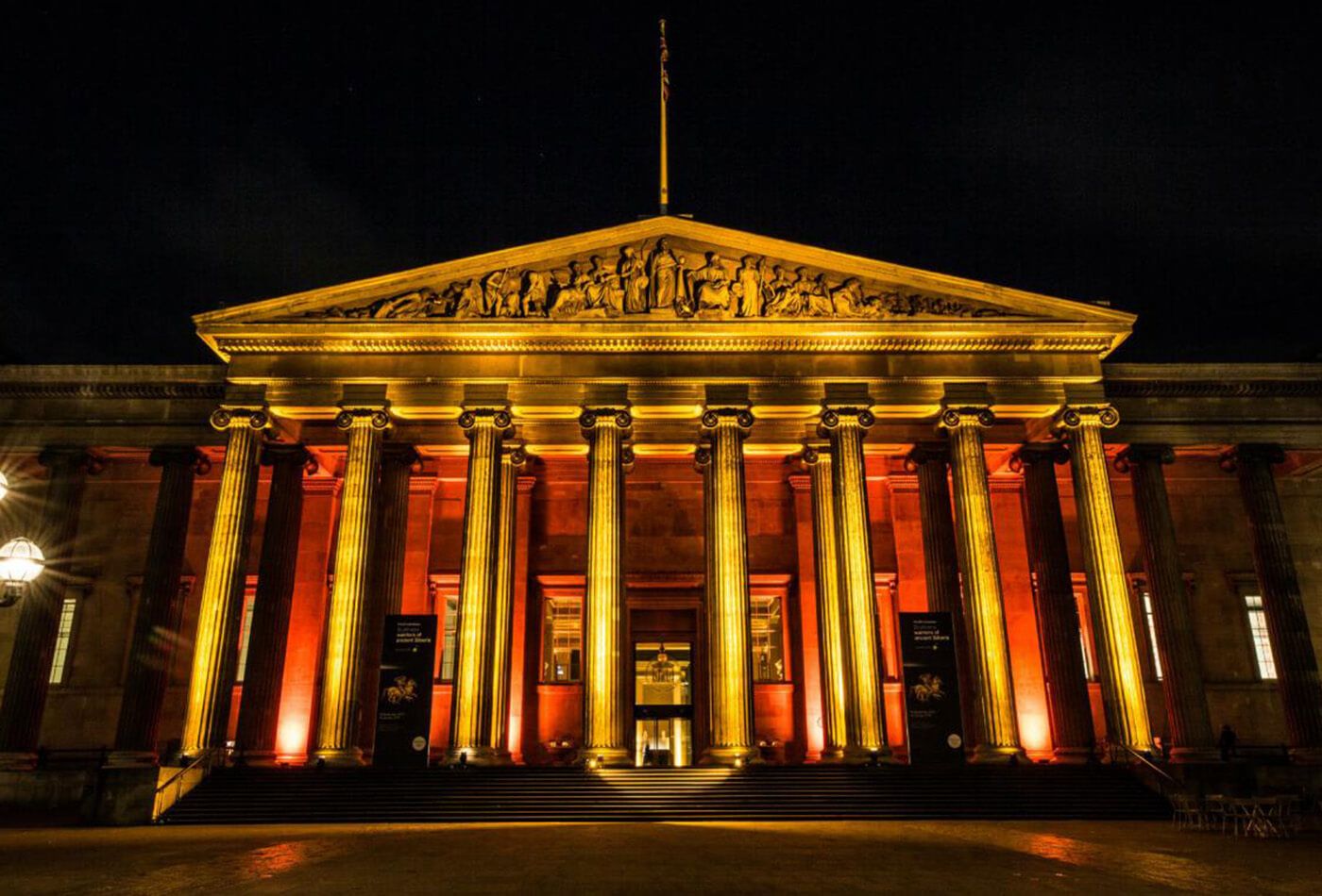 Exterior shot at night, lit up in gold and red